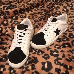 Trendy white, black and gold star tennis shoes.